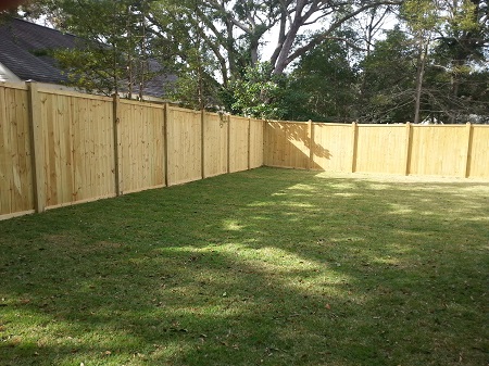 Raw fence awaiting staining by CertaPro Painters of Mobile, AL